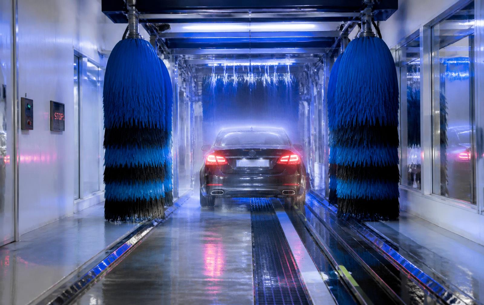 Modern automatic car wash tunnel with brushes and rinse water